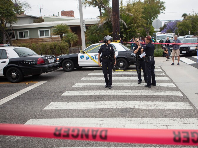 Law enforcement officials watch a road block near Santa Monica College, the scene of a shooting spree on Friday.
