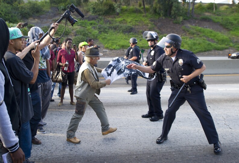 Police prepare to confront demonstrators angry at the acquittal of George Zimmerman in the death of Trayvon Martin, on the 10 Freeway, in Los Angeles, California July 14, 2013. Thousands protested in US cities overnight as President Barack Obama appealed for calm following the acquittal in Florida of a man who gunned down an unarmed black teenager. 