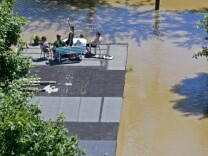 Residents sit on the roof of a garage flooded by the river Elbe in Dresden, eastern Germany, on June 5, 2013. Flooding has forced tens of thousands of evacuations across central Europe. (Photo by Robert Michael/AFP/Getty Images)