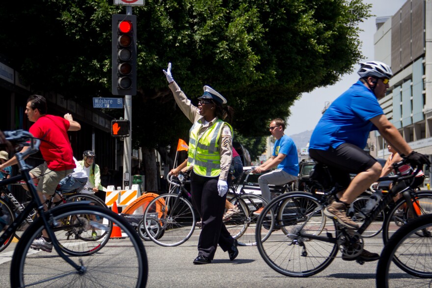 A safety officer directs traffic at a vehicle crossing point at Wilshire Boulevard and Western Avenue during CicLAvia on June 23, 2013.