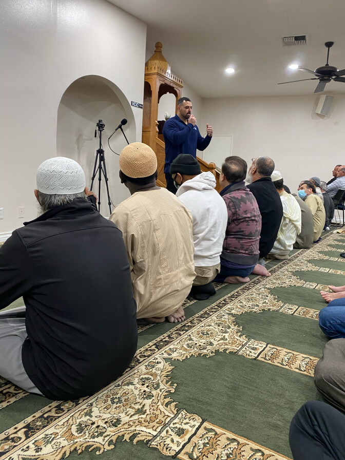 A group of men sit for Taraweeh prayers