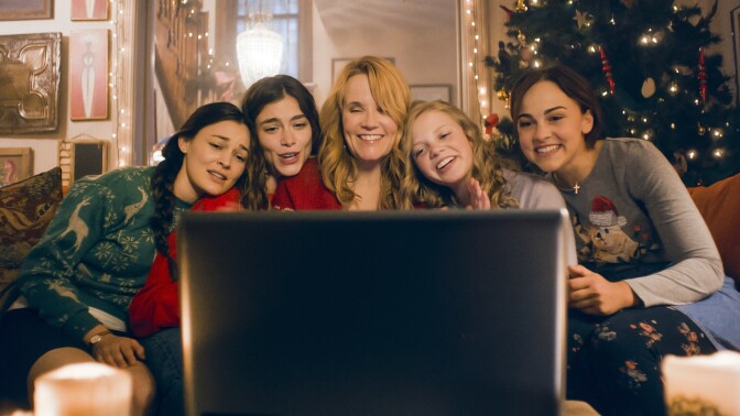 The March sisters, and Marmee (Lea Thompson), enjoy a video call with Papa March while he is deployed, in the movie "Little Women" 