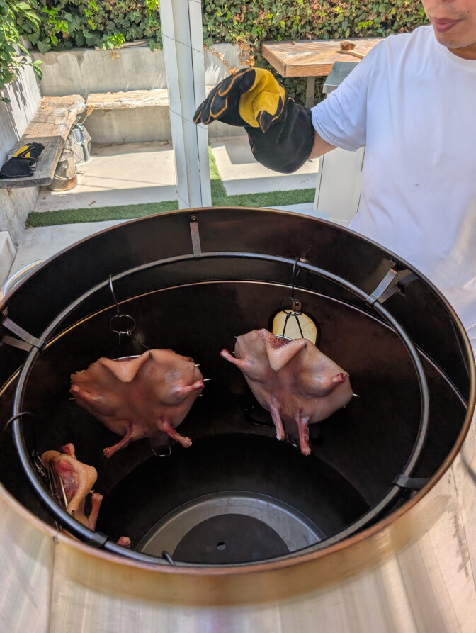 Three ducks inside an outdoor oven
