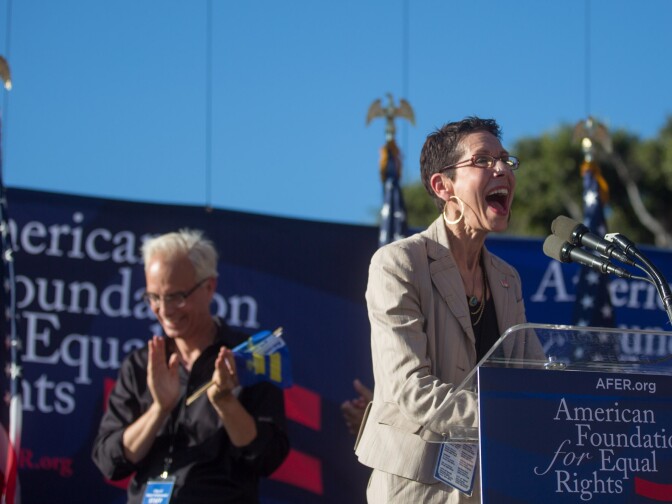 West Hollywood Mayor Abbe Land cheers on the crowd as she takes the stage at a rally for two Supreme Court decisions legalizing gay marriage in California.