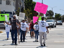 Protesters cross the street in Carson.