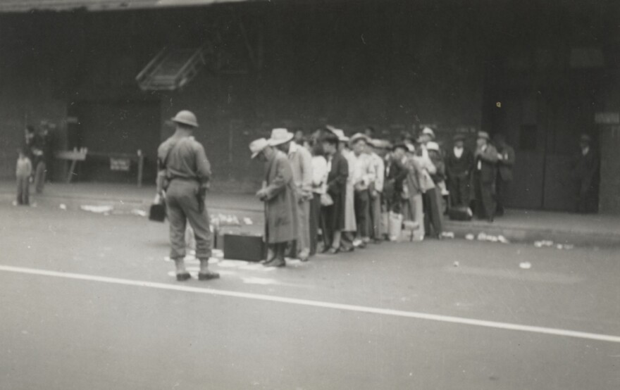 Circa April 1942: Angelenos of Japanese descent are lined up and under guard on Central Avenue in downtown Los Angeles. They are to be transported to the Santa Anita Race Track, where an Assembly Center had been set up as a waystation to internment camps. 