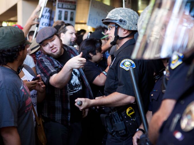 ANAHEIM, CA - JULY 24: Protesters clash with police at Anaheim City Hall to show their outrage for the shooting death of Manuel Angel Diaz, 25, on July 24, 2012 in Anaheim, California. Diaz was fatally shot July 21 by an Anaheim police officer and has sparked days of protests by the angered community. (Photo by Jonathan Gibby/Getty Images)