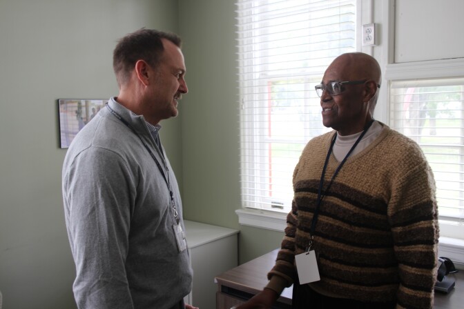 Dr. Greg Serpa (left) speaks with Korean War veteran Melvin Hilliard.