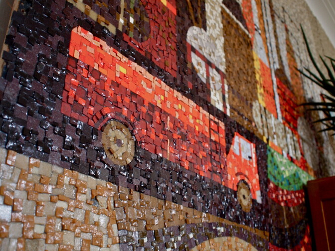 A gas truck brings up the mural's left side.