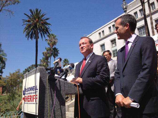 LA Sheriff's candidate Jim McDonnell speaks after receiving the endorsement of Mayor Eric Garcetti, right, outside City Hall.