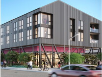 An artist's rendering of part of the Avenue 34 development in Lincoln Heights shows two sides of a three-story gray building with six windows on one side and three windows and a balcony on the other side.