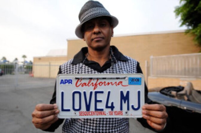 Fan Demarco DeLeon shows of his 'Love4MJ' license plate on the street near Glendale Forest Lawn Memorial Park on September 3, 2009 in Glendale, California.