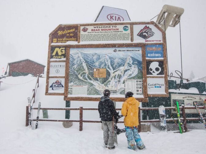 Skiers look at a map of Bear Mountain as they decide which run to take on the snowiest day of the year.
