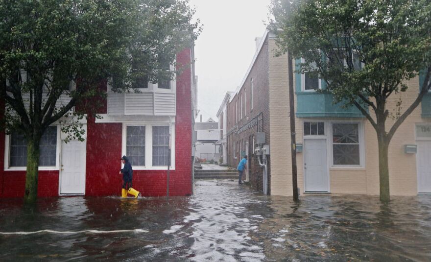 A man walks down a flooded street ahead of Hurricane Sandy on October 29, 2012 in Atlantic City, New Jersey.  New Jersey Governor Chris Christie's emergency declaration shut down the city's casinos and 30,000 residents were ordered to evacuate. The storm, which threatens 50 million people in the eastern third of the U.S., is expected to bring days of rain, high winds and possibly heavy snow.   