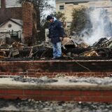 NEW YORK, NY - OCTOBER 30:  A  man looks through the debris of his destroyed home after Hurricane Sandy on October 30, 2012 in the Rockaway section of the Brooklyn borough of New York City. At least 40 people were reportedly killed in the U.S. by Sandy as millions of people in the eastern United States have awoken to widespread power outages, flooded homes and downed trees. New York City was hit especially hard with wide spread power outages and significant flooding in parts of the city.  (Photo by Spencer Platt/Getty Images)