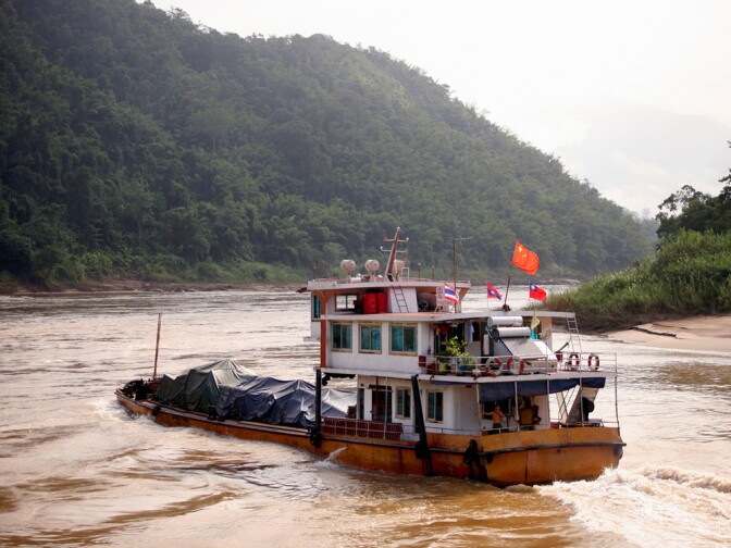 A cargo ship heads upstream toward China on the Mekong River in Myanmar. The river flirts with Myanmar for about 120 miles, mostly along the border it shares with Laos.