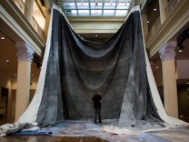 Doug McCulloh surveys the early stages of the The Great Picture installation at the Culver Arts Center in Riverside, Calif.