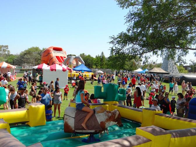 Little girl on mechanical bull at a festival