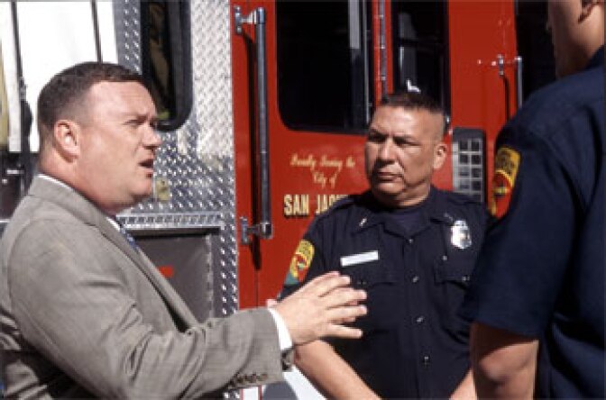 Councilman Jim Ayres speaks with firefighters