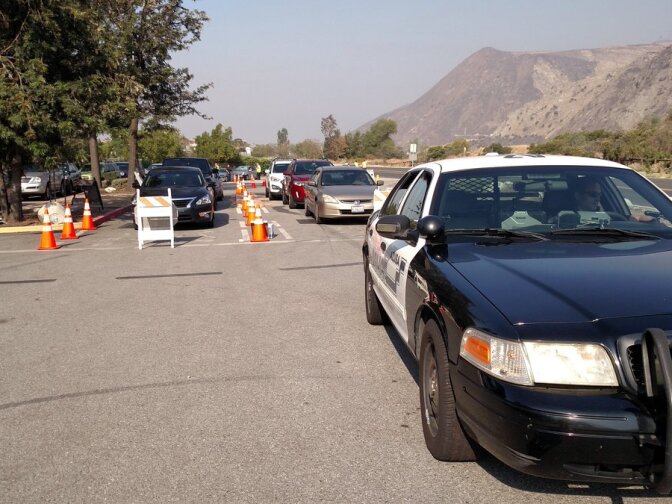 Sheriff's deputies escort Mountain Cove residents back in to their homes to retrieve essential items. 