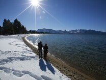 Sunlight shimmers off the snow and waters of Lake Tahoe, Monday, March 5, 2018, in South Lake Tahoe, Calif. California water officials tromped through long-awaited fresh snowdrifts in the Sierra Nevada mountains Monday, but a welcome late-winter storm still left the state with less than half the usual snow for this late point in the state's important rain and snow season. (AP Photo/Rich Pedroncelli)