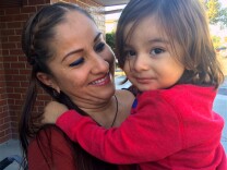 Norwalk mom, Ana Martin, with her 2-year-old son, Sebastian, wait outside a local elementary school to pick up her older children after school. She hopes Sebastian will be able to enroll in preschool when he turns 3. 