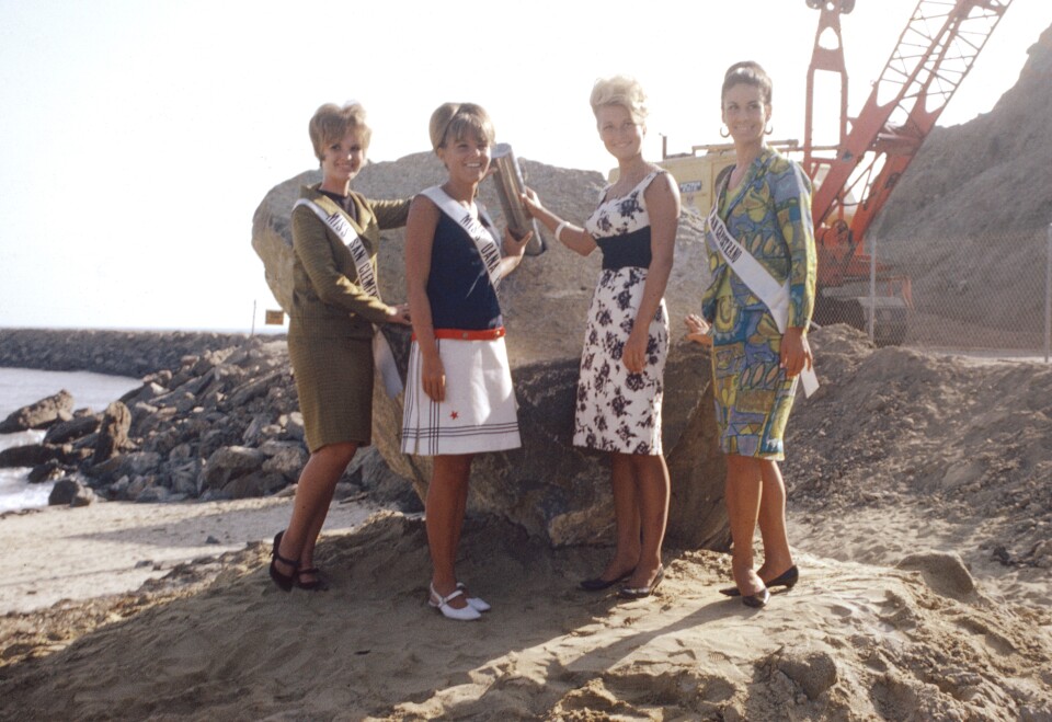 Image from a dedication ceremony for still-under-construction Dana Point Harbor and the placing of a time capsule on August 29, 1966. From left to right: Miss San Clemente, Valerie Zagwolksi; Miss Dana Point, Nancy Buenger; Miss Laguna Beach, Marsha Bennett; and Miss San Juan Capistrano, Selena Forster. (Photo courtesy Orange County Archives)