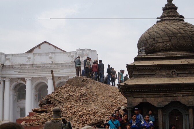 KATHMANDU, NEPAL - APRIL 25 : Local people help with rescue work at the site of a building that collapsed after an earthquake in Kathmandu, April 25, 2015. Hundreds of people have been killed in Nepal after the Himalayan nation was hit by a powerful earthquake Saturday. At least 970 people have been killed in different parts of the country according to figures released by the Nepali Police. (Photo by Sunil Pradhan/Anadolu Agency/Getty Images)