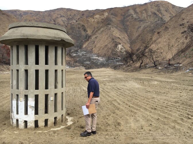 Civil Engineer Mike Miranda of Los Angeles County Public Works, examines a large drain inside the Brace Canyon Debris Basin in Burbank. The basin was burned over in the La Tuna Fire and later cleared out so it can catch mud coming off the burned Verdugo mountains.