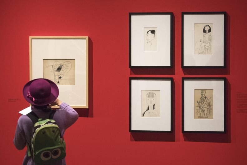 Freelance writer Jana Monji looks at the work from artist Miguel Covarrubias, part of the "Winds from Fusang: Mexico and China in the Twentieth Century" exhibit during a media tour of the newly renovated USC Pacific Asia Museum, December 6, 2017.  (Photo/Gus Ruelas)