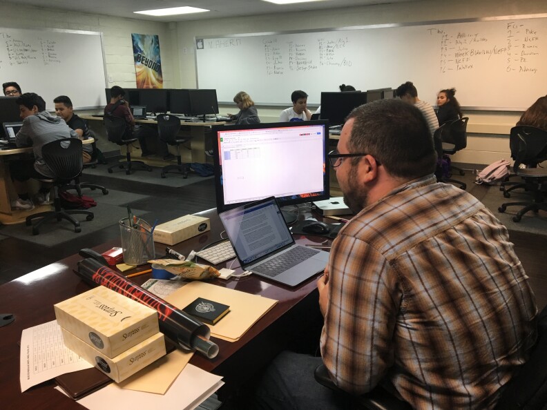 Cameron Ahern, an "advisor" in the iGranada program, monitors students working independently on core class work.