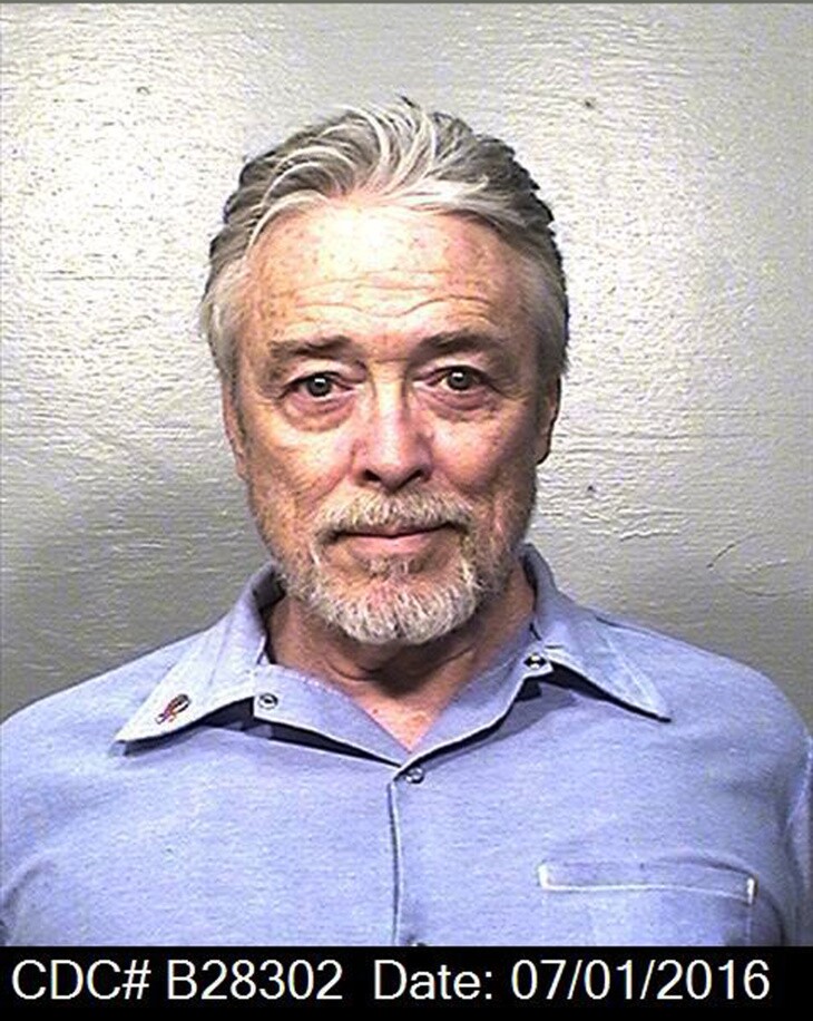 Beausoleil in a blue button down shirt and great hair and beard.