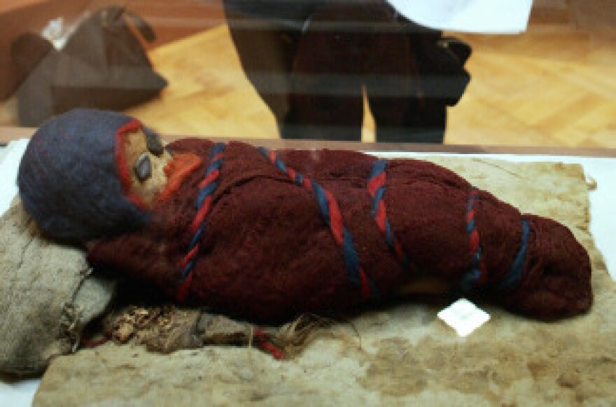 A baby mummy, which was unearthed at an ancient tomb in Chinese city of Qarqan in 1985, is on display during the press preview of the Silk Road Exhibition in Tokyo.