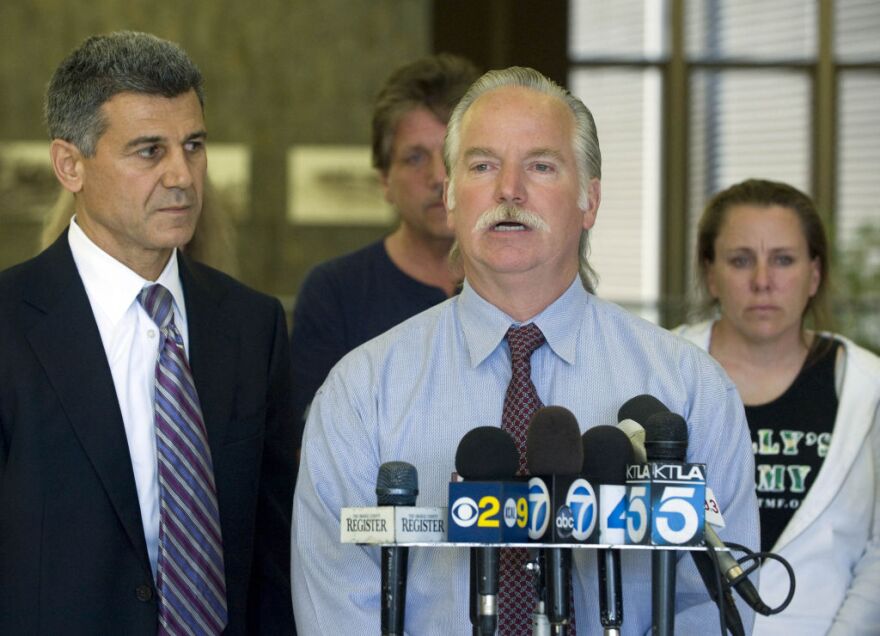 Ron Thomas speaks to the media after Tuesday's preliminary hearing in Santa Ana.