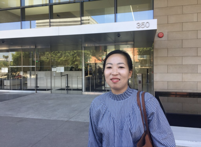 U.S. Army veteran Yea Ji Sea stands outside of a federal courthouse in downtown Los Angeles ahead of a hearing to determine whether the government needs to speed up her citizenship application.