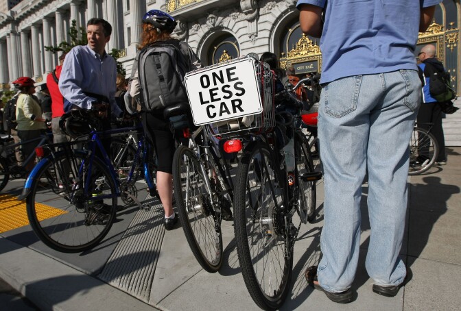 SAN FRANCISCO - MAY 14:  A sign reads "one less car" on the back of a bicycle at an "energizer station" at San Francisco city hall where bicycle advocates handed out food and drink on Bike to Work Day May 14, 2009 in San Francisco, California. Over 150,000 bicyclists are expected to participate in the 15th annual Bike to Work Day event that promotes exercise and helps reduce pollution.  (Photo by Justin Sullivan/Getty Images)