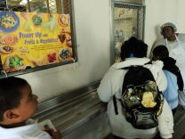A cafeteria worker supervises lunches for school children at the Normandie Avenue Elementary School in South Central Los Angeles on December 2, 2010.  First Lady Michelle Obama, a champion of measures to fight childhood obesity in the United States, welcomed passage in Congress Thursday of a law aimed at improving the quality of school meals. The House of Representatives earlier passed The Healthy, Hunger-Free Kids Act, following passage by the Senate. The bill now awaits President Barack Obama's signature to become law. It allows the federal government to encourage schools, through subsidies, to serve students meals that respect nutritional standards set by the National Academy of Sciences. Michelle Obama called the bill a "groundbreaking piece of bipartisan legislation that will significantly improve the quality of meals that children receive at school and will play an integral role in our efforts to combat childhood obesity.          