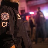 An agent for Immigration and Customs Enforcement, or ICE, stands outside of a raid on human traffickers.