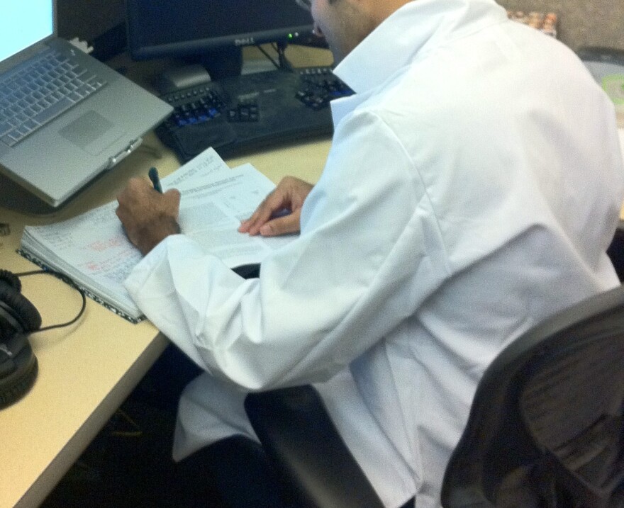 File: A researcher at CS/ECE wears a lab coat.