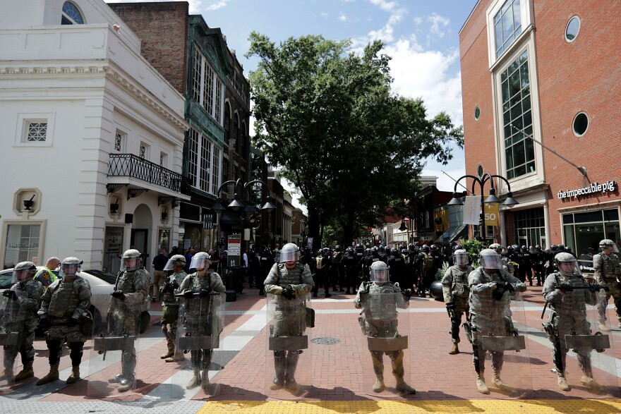 CHARLOTTESVILLE, VA - AUGUST 12:  Members of the Virginia National Guard wear body armor and carry riot shields while standing guard on the pedestrian mall following violence at the United the Right rally August 12, 2017 in Charlottesville, Virginia. Gov. Terry McAuliffe declared a state of emergency after white nationalists, neo-Nazis and members of the "alt-right" violently clashed with anti-facist and Black Lives Matter counter-demonstrators at Emancipation Park.  (Photo by Chip Somodevilla/Getty Images)