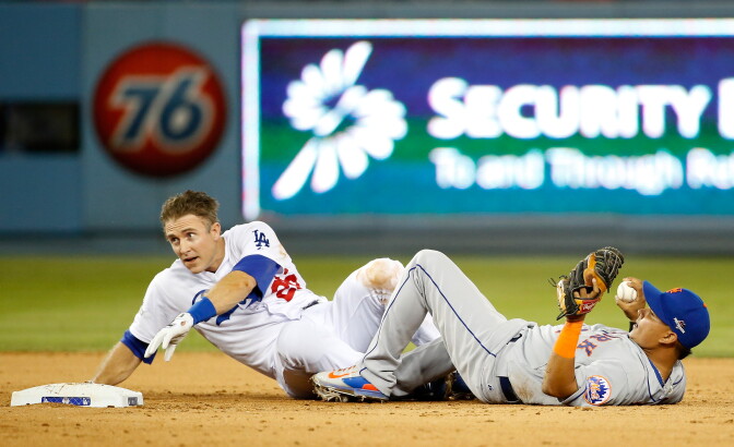 LOS ANGELES, CA - OCTOBER 10:  Ruben Tejada #11 of the New York Mets is hit by a slide by Chase Utley #26 of the Los Angeles Dodgers in the seventh inning in an attempt to turn a double play in game two of the National League Division Series at Dodger Stadium on October 10, 2015 in Los Angeles, California.  (Photo by Sean M. Haffey/Getty Images)
