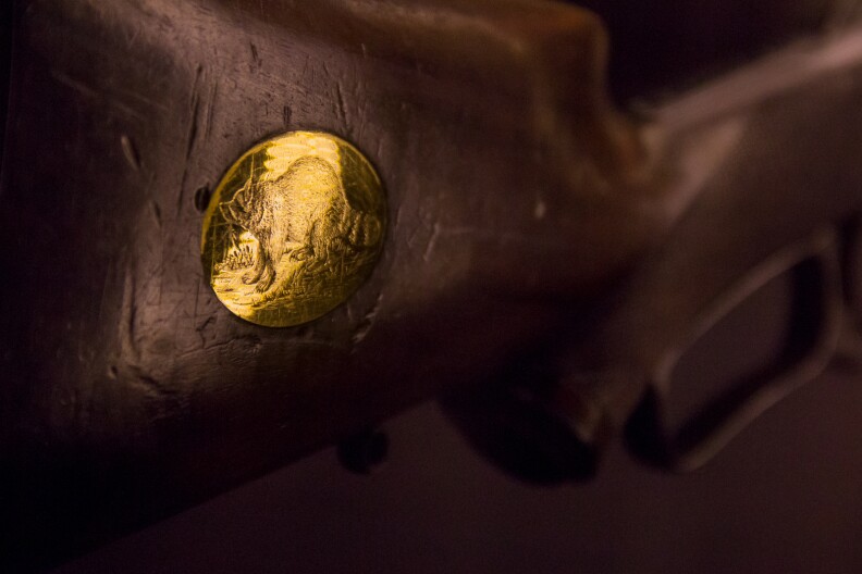 Theodore Roosevelt’s 1876 Winchester Carbine rifle with gold raccoon engraving.