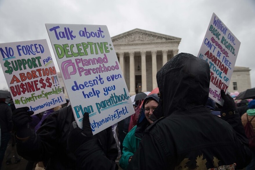 Anti-abortion activists demonstrate  in front of the US Supreme Court in Washington, DC, on March 20, 2018 as the court hears a challenge to California law requiring anti-abortion pregnancy clinics to distribute information on family planning services.  / AFP PHOTO / NICHOLAS KAMM        (Photo credit should read NICHOLAS KAMM/AFP/Getty Images)