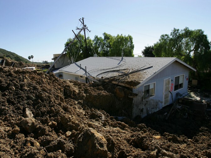 LA CONCHITA, CA - JANUARY 14:  A home damaged in the deadly mudslide that killed at least 10 people is one of those that residents will not be allowed to enter on the first day that evacuated residents are allowed to return to their devastated community January 14, 2005 in La Conchita, California. With at least three people still missing, rescuers suspended search efforts after the hillside above shifted, raising concern that another mudslide could occur. 15 homes were destroyed and 16 damaged when the mudslide poured over part of the small seaside town of 260 people at the end of the area's heaviest rainfall in a 15-day period since records began in 1921.     (Photo by David McNew/Getty Images)