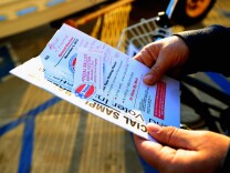 A voter holds a sample ballot with her grocery list scribbled on the front page after voting for the midterm elections at Los Angeles County Lifeguard headquarters on November 2, 2010.