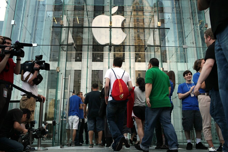 NEW YORK - JUNE 24:  Customers wait in line at the flagship Apple Store on Fifth Avenue for the new iPhone 4, which went on sale this morning on June 24, 2010 in New York City. People waited outside of stores overnight to be first in line when doors opened at 7 a.m. in New York and at 8 a.m. local time in Germany, Japan, France and the United Kingdom. The iPhone 4 will cost $199 for a 16-gigabyte version and $299 for a version with 32 gigabytes of storage.  (Photo by Spencer Platt/Getty Images)