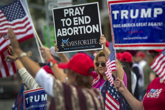 ANGELES, CA - JUNE 02: A woman holds an anti-abortion placard as supporters of President Donald Trump rally outside the Wilshire Federal Building on June 2, 2019 in Los Angeles, California. The rally was billed as the first of several grassroots rallies in Los Angeles for the re-election of Trump in 2020. (Photo by David McNew/Getty Images)