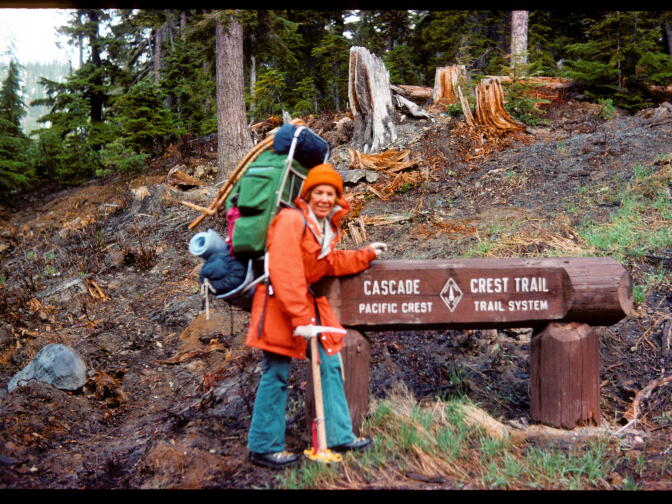 Teddi Boston poses with a Pacific Crest Trail sign in 1976. Boston was able to take a few self-portraits during her solo hike using her camera's auto-timer. 