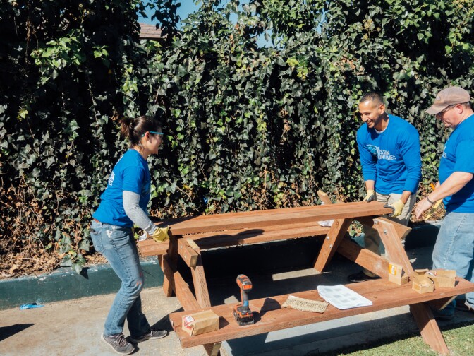 A picnic table comes together at Gonzaque Village in Watts during a volunteer event organized by The Mission Continues.