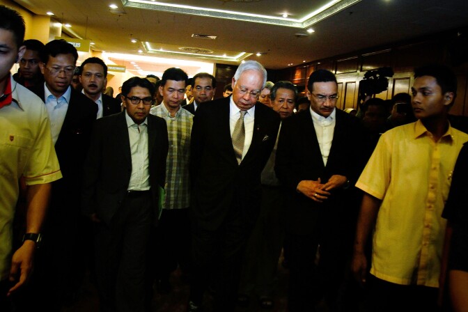 Prime Minister of Malaysia (C), Najib Razak leaves after an ad hoc press conference on March 24, 2014 in Kuala Lumpur, Malaysia. Prime Minister Najib Razak spoke at the press conference to announce that fresh analysis of available satellite data has concluded that missing flight MH370's final position was in the southern Indian Ocean. French authorities reported a satellite sighting of objects in an area of the southern Indian Ocean where China and Australia have also reported similar sightings of potential debris from the flight that went missing on March 8. 
